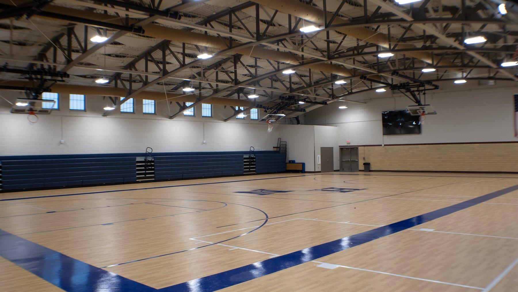 The restored Holy Name field house gymnasium with its historic truss ceiling